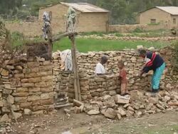Two men building a stone enclosure Stock Footage