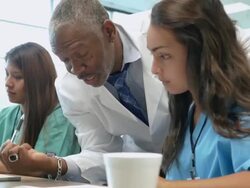 African American professor of medicine tutoring nursing or medical students Stock Footage