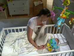 HD CRANE: Mother Stroking Her Sleepless Baby Stock Footage