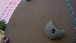 A climber uses hand holds to climb an artificial rock wall. Stock Footage