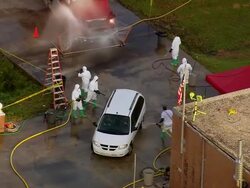 September 12, 2005 aerial zoom out vehicles being cleaned at decontamination site / New Orleans, Louisiana Stock Footage