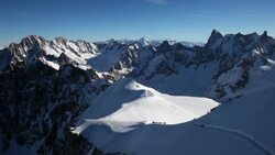 Skiers ski down the Aiguille du Midi at Chamonix ski resort in France. Stock Footage