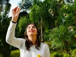 beautiful young woman with white dress blowing bubbles Stock Footage