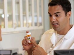 "pharmacist taking a credit card for a prescription from a senior customer/Richmond,Virginia, USA" Stock Footage