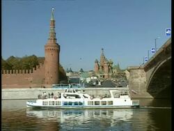 WA view across Moskva river to Kremlin tower and St. Basils in distance. Ferry passes in foreground, Moscow Stock Footage