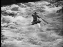 B/W 1961 2 Czech men kayaking on rapids in kayaking slalom competition / newsreel Stock Footage