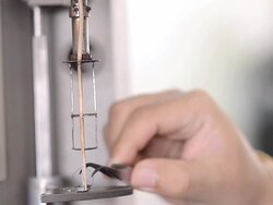 put solid sample on platinum pan in TGA Stock Footage