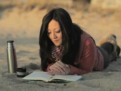 Woman reading on beach Stock Footage