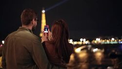A couple takes a photo of the Eiffel Tower. Stock Footage