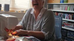 Happy Senior Woman Doing a Hobby Sewing A Quilt Stock Footage