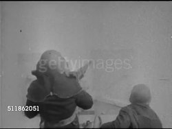 1942: UNITED STATES COAST GUARD: WS Ship on ocean. MS BEHIND US Soldier firing anti-aircraft artillery in smoke. MS US Sailors loading, firing Depth Charges into water, WS Explosion of water.  WWII, World War II. Instructional Video