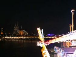 MS Shot of Amusement ride star shape in front of Cologne Cathedral, Funfair / Cologne, Germany Stock Footage