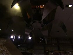 A claw grappler operates at a paper recycling facility. Stock Footage