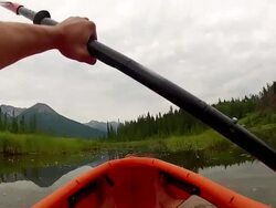 POV of person kayaking across mountain marshland Stock Footage