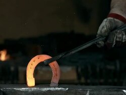 HD Super Slow-Mo: Blacksmith With Finished Horseshoe Stock Footage