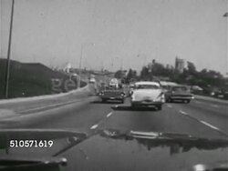1965: FREEWAY TRAFFIC: RAPID MOTION VS (POV Front seat of moving vehicle) Driving up access ramp onto highway, merging, driving center lane, moving in traffic, changing lanes. HA TD VS Expressway traffic. WS Driving, rapidly approaching tall road sig Instructional Video