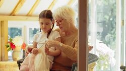 Grandmother teaching granddaughter knitting Stock Footage