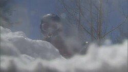 A rescue worker finds a snow-covered vehicle following a natural disaster. Stock Footage