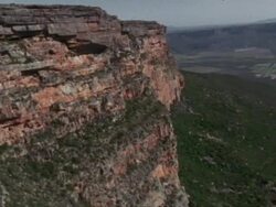 Aerial past mountain to escarpment beyond, Namaqualand, South Africa Stock Footage