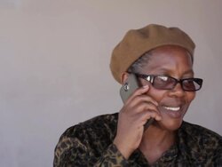 Senior african woman talking to a friend on her cellphone Stock Footage