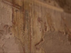Close Up, tilt-down - An archeologist uses a Q-tip to wipe away dust from hieroglyphics / Egypt Stock Footage
