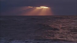 Sun beams stream down from clouds above the sea. Stock Footage