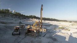 A man operates a large machine at a granite quarry. Stock Footage