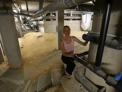 Engineer woman inspecting the underground of a big technical plant Stock Footage