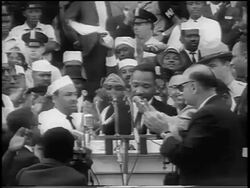 B/W August 28, 1963 Martin Luther King at podium with crowd clapping at March on Washington / newsreel Stock Footage