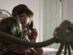 MS Girl (2-3) sitting on bed and playing with doll, American Fork, Utah, USA Stock Footage
