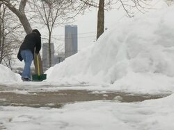 MS Woman in jeans shoveling snow from walkway / Saint Paul, Minnesota, United States  Stock Footage