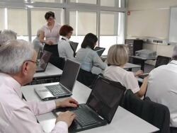 HD DOLLY: Lecturer Assisting Business Computer Class Stock Footage