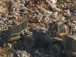 CU AERIAL Shot of truck working at Landfill (outside Fairmont Mill) / South Carolina, United States Stock Footage