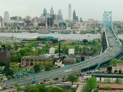 Time lapse, Philadelphia cityscape, commuter traffic races across Ben Franklin Bridge. Stock Footage