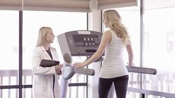 Physical therapist working with young adult female Stock Footage