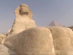 Medium Long Shot, crane push-in - The Great Sphinx sits in front of the Great Pyramids / Egypt Stock Footage