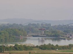 WS AERIAL View of container ship moving on river and farm field and houses / Germany Stock Footage