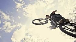 SLO MO Mountain biker jumping over the ramp Stock Footage