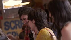 Group of friends in Austin record shop look at vintage album and laugh Stock Footage