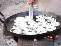 Indian Vendor making Jalebi Funnel Cake at Road side stall Stock Footage