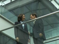 Ws male and female meeting on office walkway with handshake, UK Stock Footage