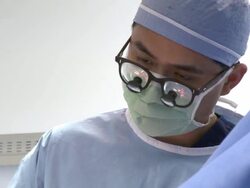 Doctors in operating room performing surgery Stock Footage