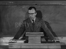 1951: HARVARD UNIVERSITY ACADEMICS: Angled WS Students on steps of building w/ six columns, VS Professor teaching class, WS 'The Problem of International Cartels' outline I-V on blackboard, SOT talking about U.S. Antitrust laws, our views here or? Instructional Video