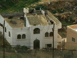 MS Shot of Palestinian house with Israeli separation wall in front / Ma'ale Gilboa, Samaria, Israel Stock Footage