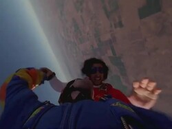 Two skydivers exit the plane together holding hands and spin and flip around. Stock Footage