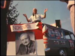 Politician campaigns out of the back of his car Stock Footage