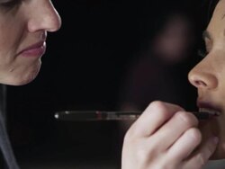 CU PAN Female fashion model backstage at fashion show make-up artist applying make-up Stock Footage