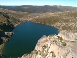 WA Aerial track over Australian alpine lake in summer Stock Footage