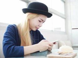 Woman playing smartphone at coffee shop cafe Stock Footage