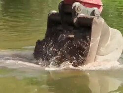 CU TS Shot of construction waste material immersing into water at bridge construction site preparing demolition of old bridge / Wiltingen, Rhineland Palatinate, Germany Stock Footage